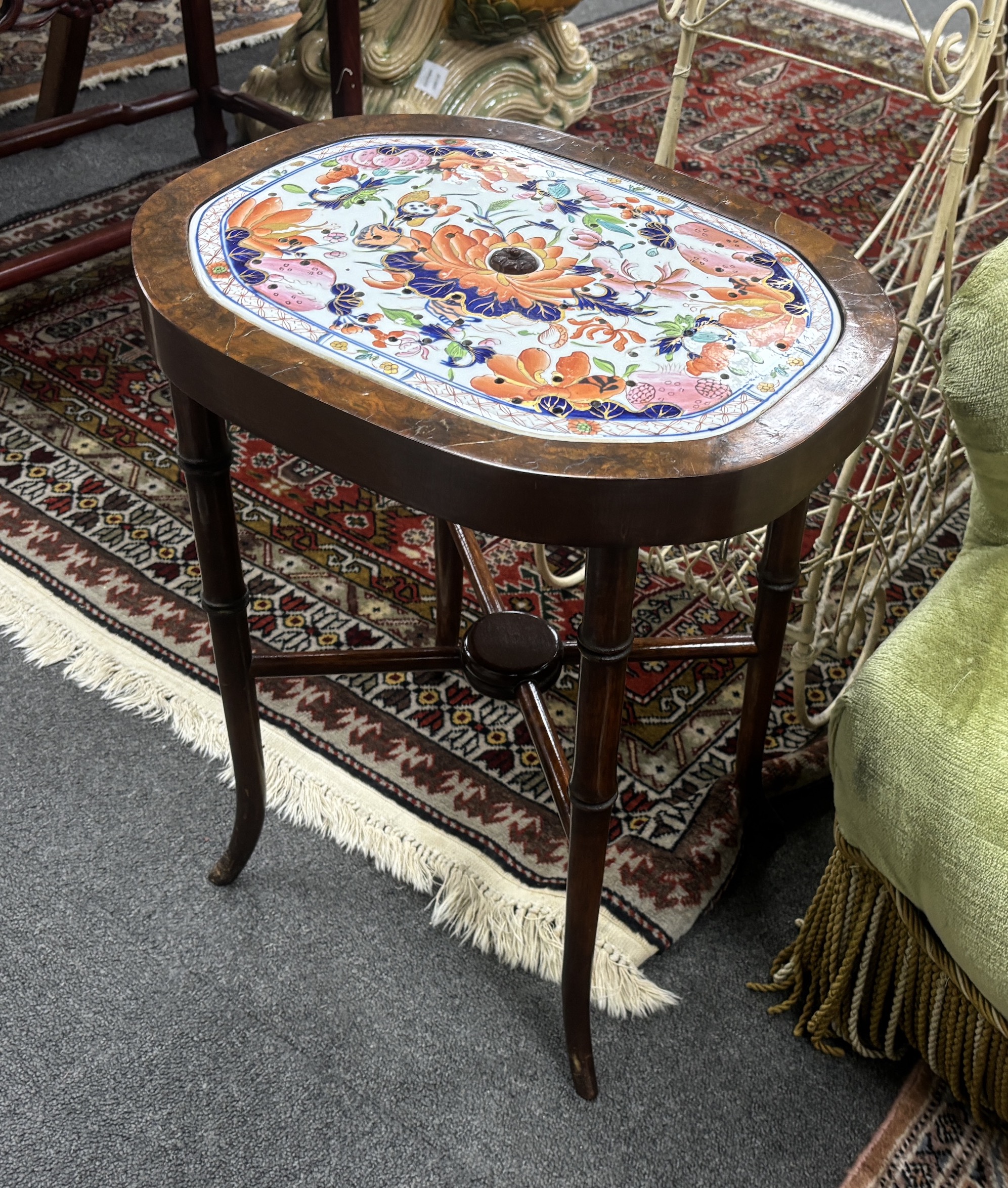 A pair of American walnut tables, each inset with Mason’s ironstone strainer panels, 47cm high